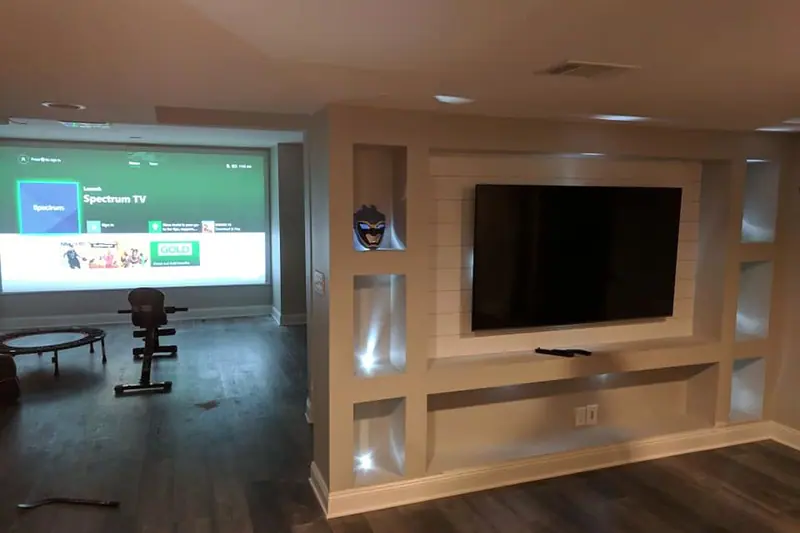 Basement family room with a built-in lit media wall