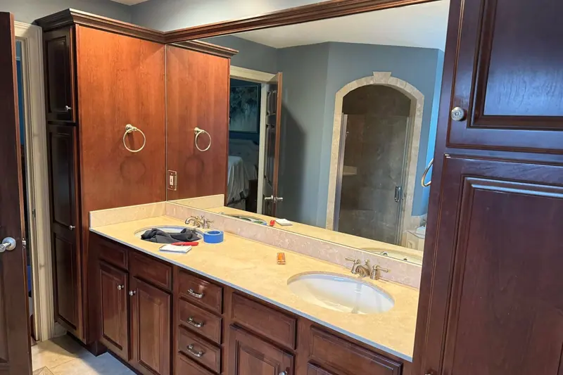 Original bathroom with cherry double vanity, cultured-marble top and blue walls